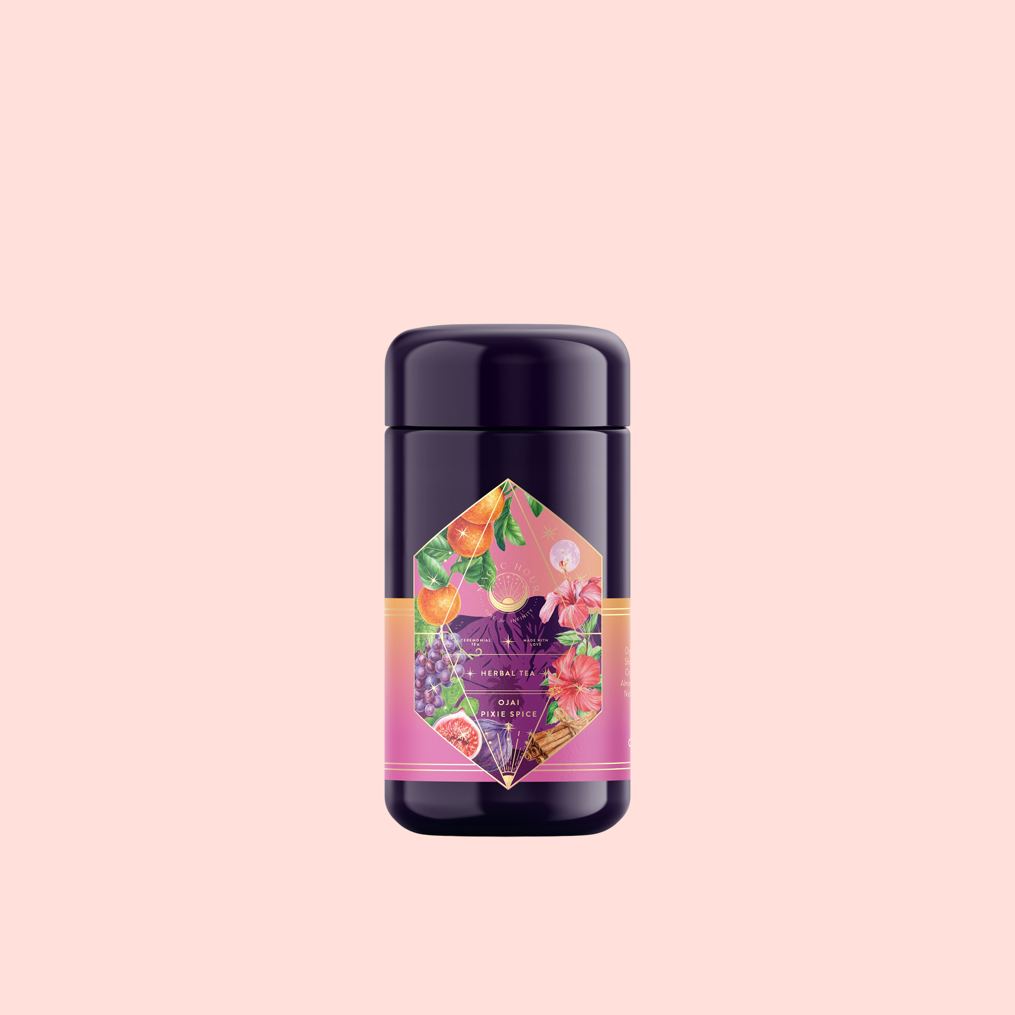 A dark purple cylindrical container of Pink Moment Pixie - Hibiscus Tangerine Dream Herbal Tea with a colorful label showing oranges, grapes, elderberry, and flowers on a light pink background.