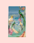 A vibrant coffee bag for Tulum Horchata Chai shows illustrated parrots, tropical flowers, and leaves, with a central geometric diamond and pyramid steps below, celebrating adaptogenic wellness blends on a light pink background.