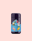 A dark purple cylindrical container with a bright blue label showing fruits and flowers sits on a light pink background, highlighting Summer in Amalfi—a refreshing blend of Organic Lemon Peel and Green Tea Oolong Mediterranean tea.