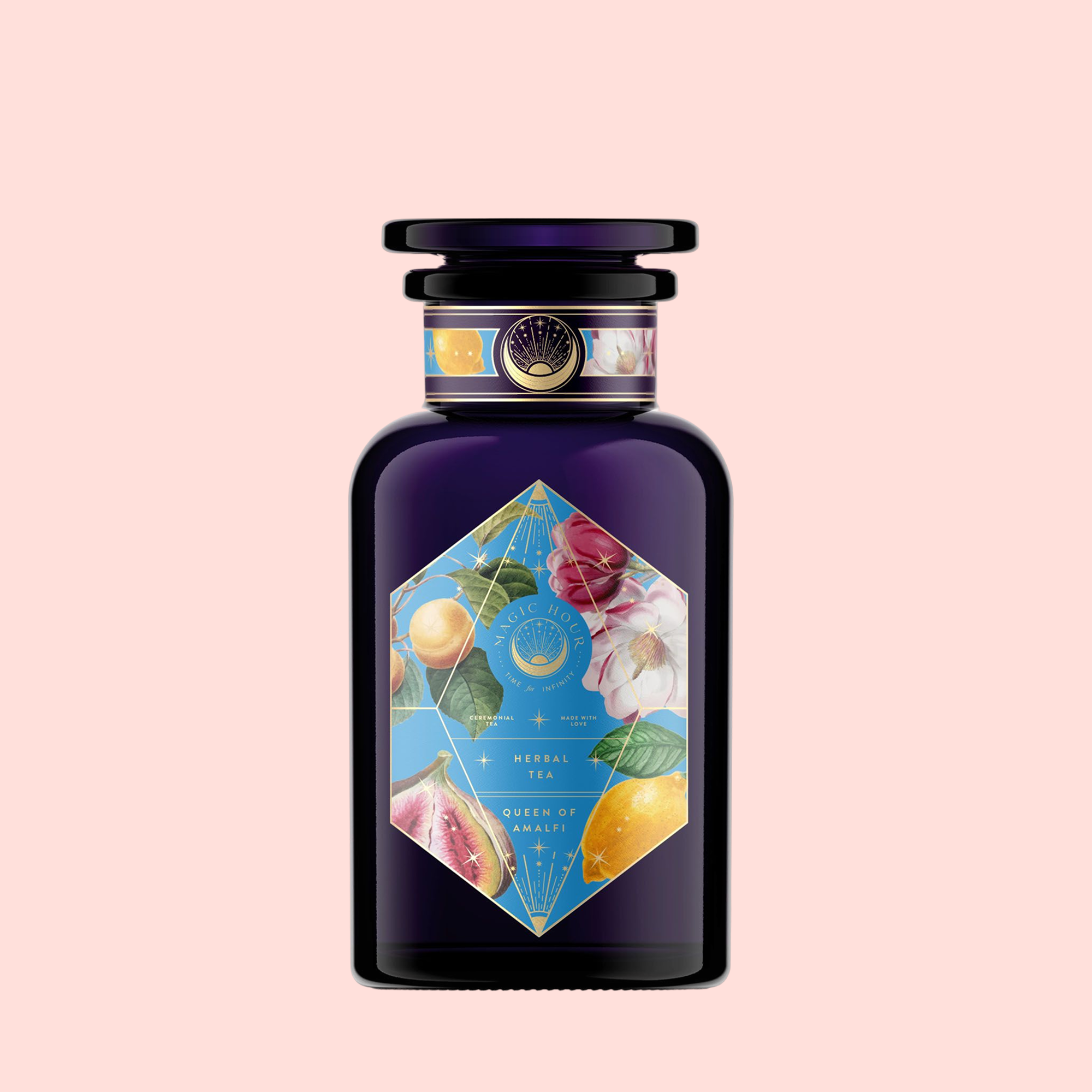 A dark purple glass bottle with a black cap and a colorful label showing figs, lemons, flowers, and leaves on light pink. The label reads "Summer in Amalfi"—a Mediterranean tea with organic herbal tea notes.