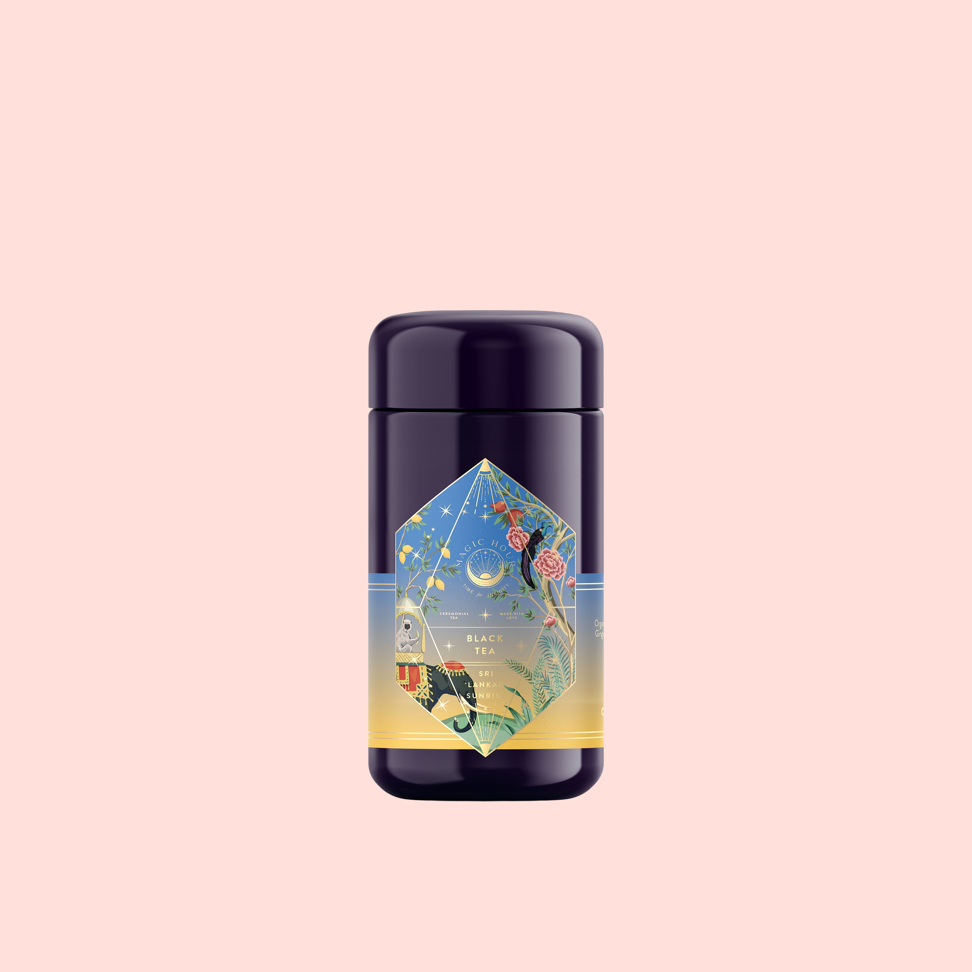 A tall, dark tea canister labeled "Sri Lankan Sunrise" features celestial and floral art with vibrant colors, highlighting Sri Lankan breakfast tea and Organic Rose Petals, set against a plain light pink background.