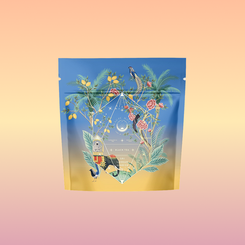 Sri Lankan Sunrise: a vibrant tea package with tropical plants, flowers, and exotic birds on a blue-to-yellow gradient, set against a peach and pink background—perfect for highlighting premium organic black tea.