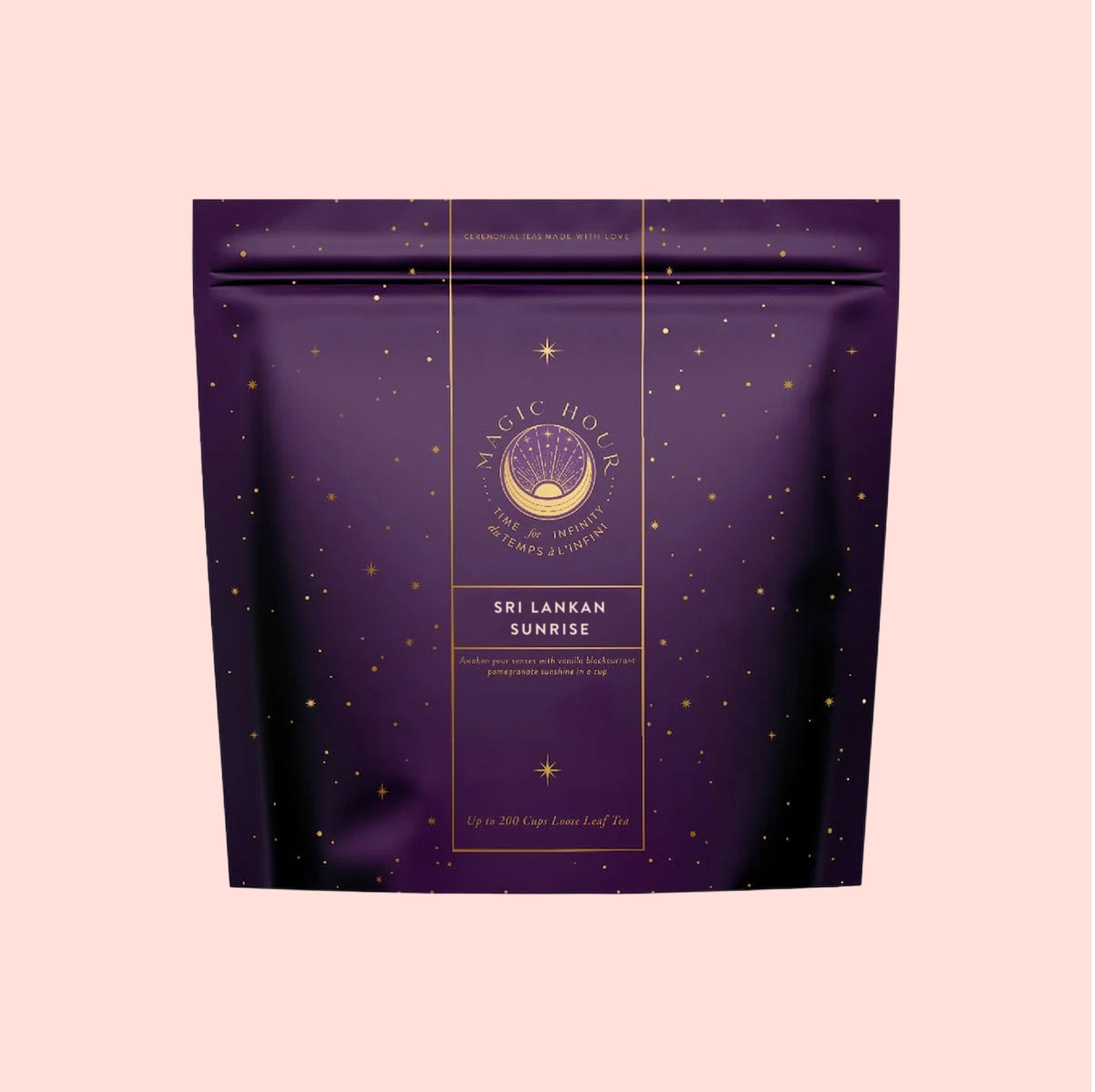 A purple Magic Hour pouch labeled "Sri Lankan Sunrise," featuring gold stars and text, stands against a pale pink background, evoking the vibrant taste of Sri Lankan breakfast tea within.