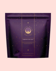 A light pink, resealable pouch of "Turkish Delight" herbal blend features gold stars and a circular "Magic Hour" logo. Inspired by Istanbul, this caffeine-free tea is packaged in a purple bag with elegant details.