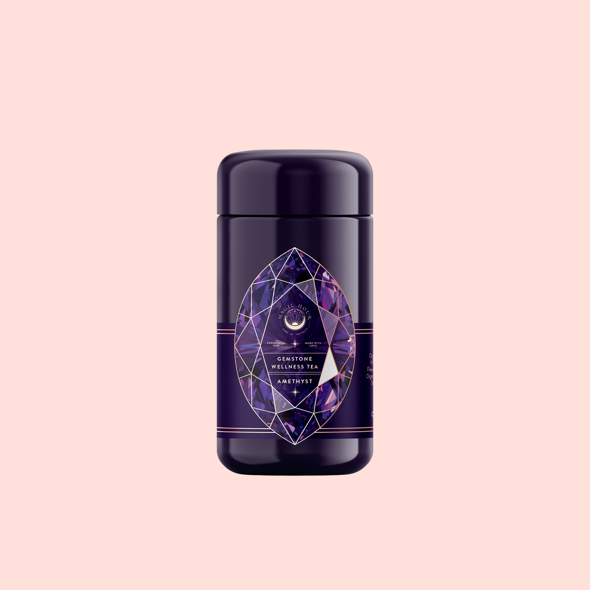 A dark purple cylindrical canister with a geometric amethyst label displays “Claritybox Wellness Tea” and “Amethyst: Strawberry-Passionfruit Gemstone Wellness Tea,” highlighting its herbal blend against a pale pink background.