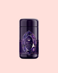 A dark purple cylindrical canister with a geometric amethyst label displays “Claritybox Wellness Tea” and “Amethyst: Strawberry-Passionfruit Gemstone Wellness Tea,” highlighting its herbal blend against a pale pink background.