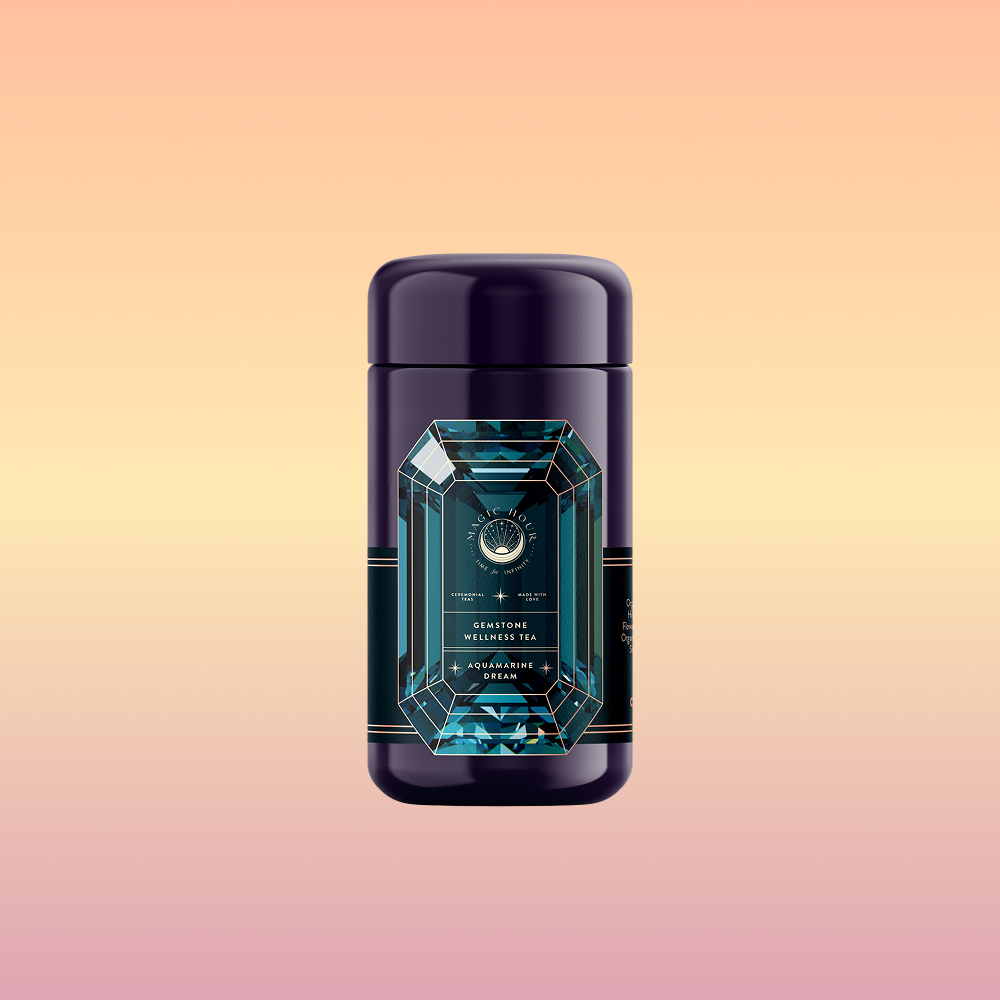 A dark purple cylindrical canister labeled "Aquamarine Dream - Soothing Herbal Ayurvedic Adrenal Tonic" with a teal and gold geometric design, featuring a calming blend, sits centered on a pastel peach, yellow, and pink gradient background.