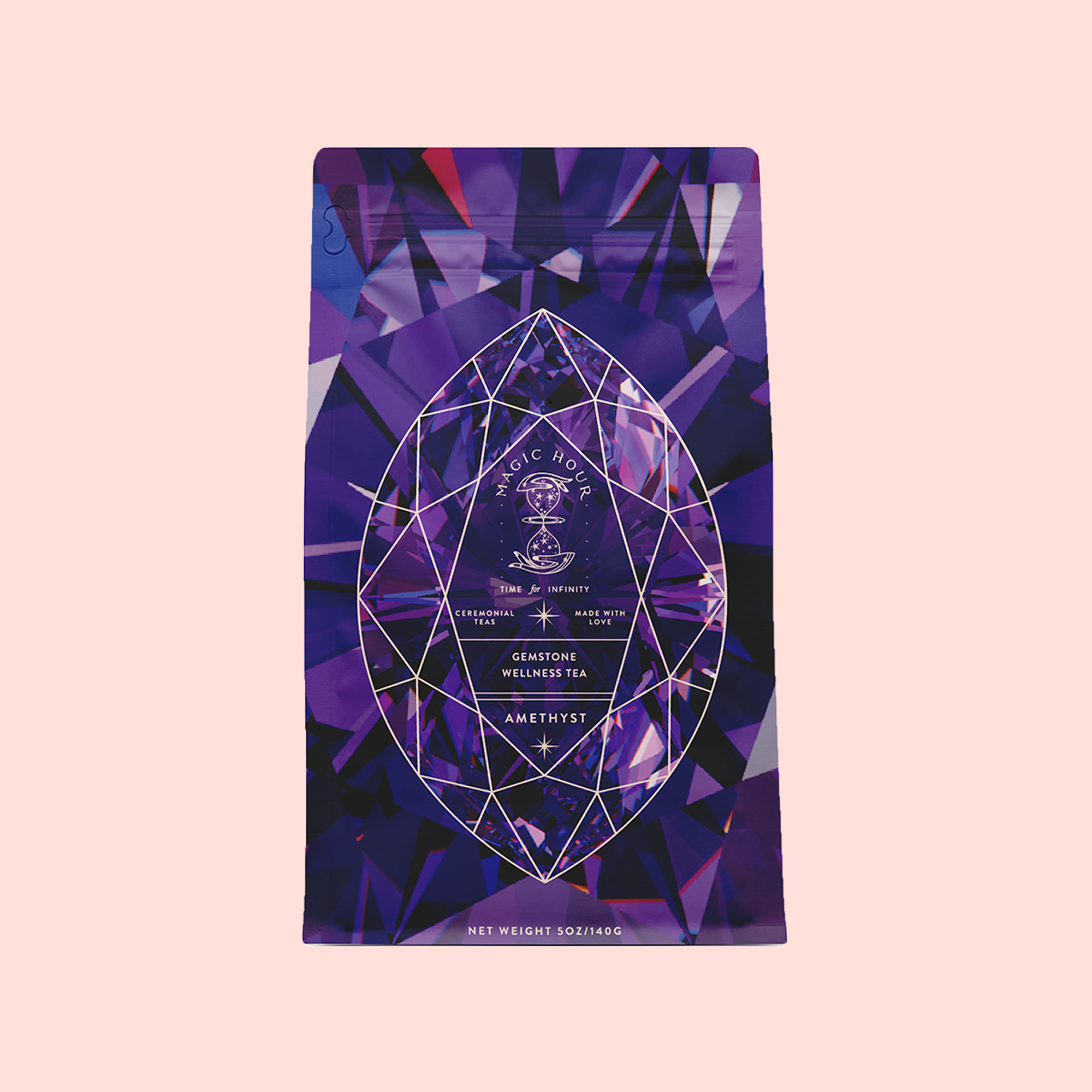 A purple geometric package labeled "Amethyst: Strawberry-Passionfruit Gemstone Wellness Tea" with a crystal-inspired design promotes spiritual wellness and an organic herbal blend against a light pink background.
