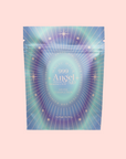 A holographic pastel packet labeled "999: Adaptogenic Pineapple-Mint-Jasmine Herbal Tea" with starburst and star designs, set against a light pink background—ideal for crown chakra healing and peaceful sleep support.
