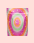 A vibrant tea package with a radiant starburst in pink, green, yellow, and white is labeled “333: Mango-Lemon Balm-Rose Herbal Tea with Passionflower” and channels creativity. Net weight: 1.5 oz.
