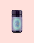 A purple bottle labeled "999: Adaptogenic Pineapple-Mint-Jasmine Herbal Tea" with a glowing blue and gold design suggests a celestial blue blend, displayed against a pale pink background.