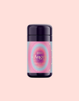 A dark purple cylindrical container with a vibrant pink and blue label reading "222: Hibiscus-Papaya Oolong with Roses" rests on a light pink background.
