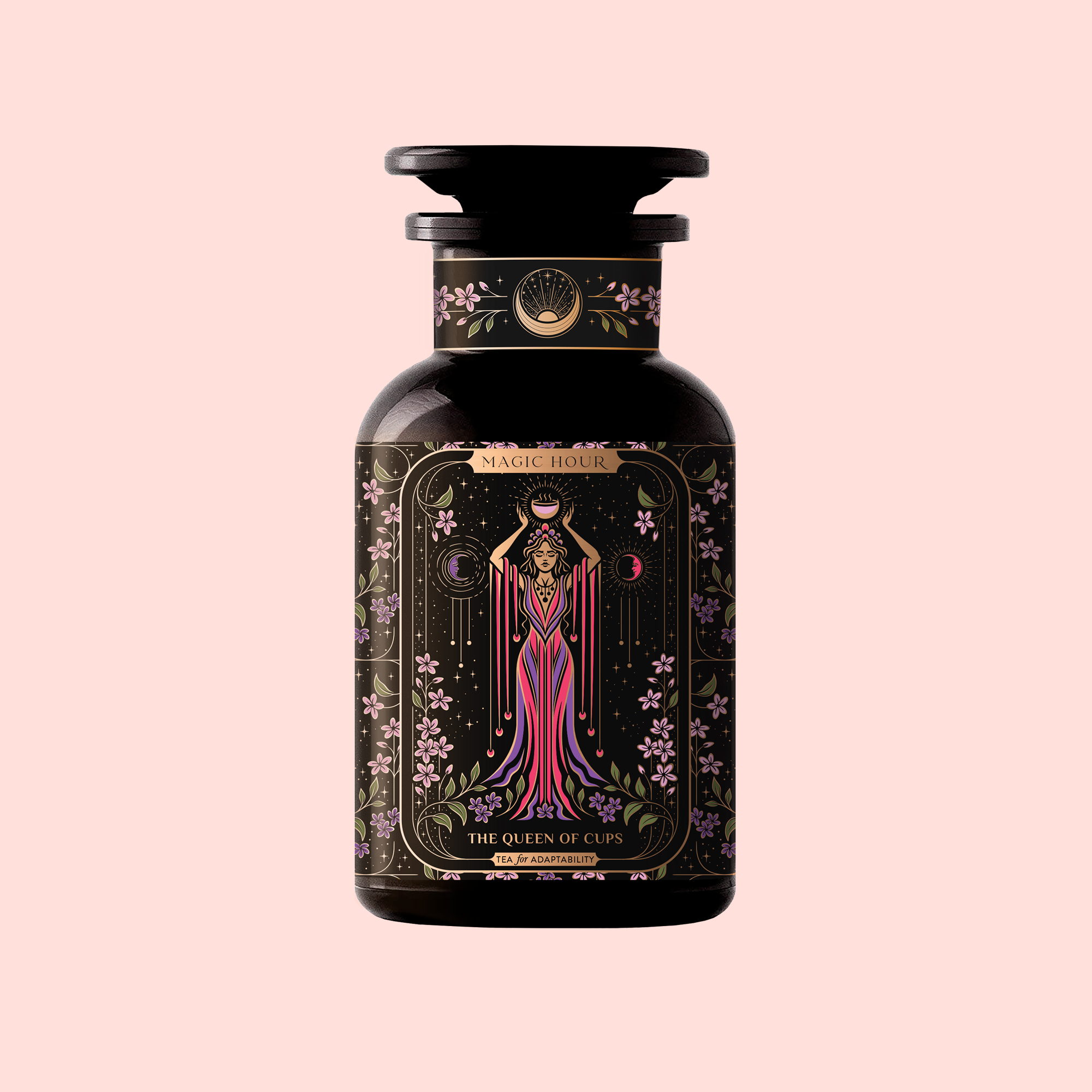 A dark glass bottle labeled "The Queen of Cups: Hibiscus-Vanilla-Berry Tea for Balance &amp; Heart Health" features ornate art of a regal woman in pink with celestial symbols, celebrating balance and heart health on a light pink background.