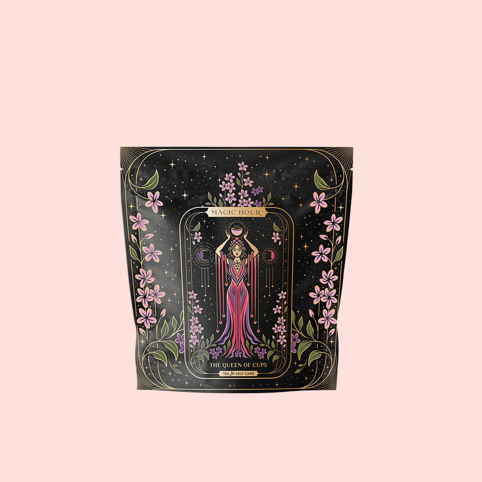 A pale pink package of The Queen of Cups: Hibiscus-Vanilla-Berry Tea for Balance &amp; Heart Health features pink flowers, gold accents, and a woman in a flowing pink dress holding cups, evoking harmony and self-care.