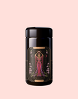 The Queen of Cups: Hibiscus-Vanilla-Berry Tea for Balance & Heart Health comes in a black canister featuring an illustrated woman in a flowing red dress with floral designs on a pale pink background—perfect for emotional balance.