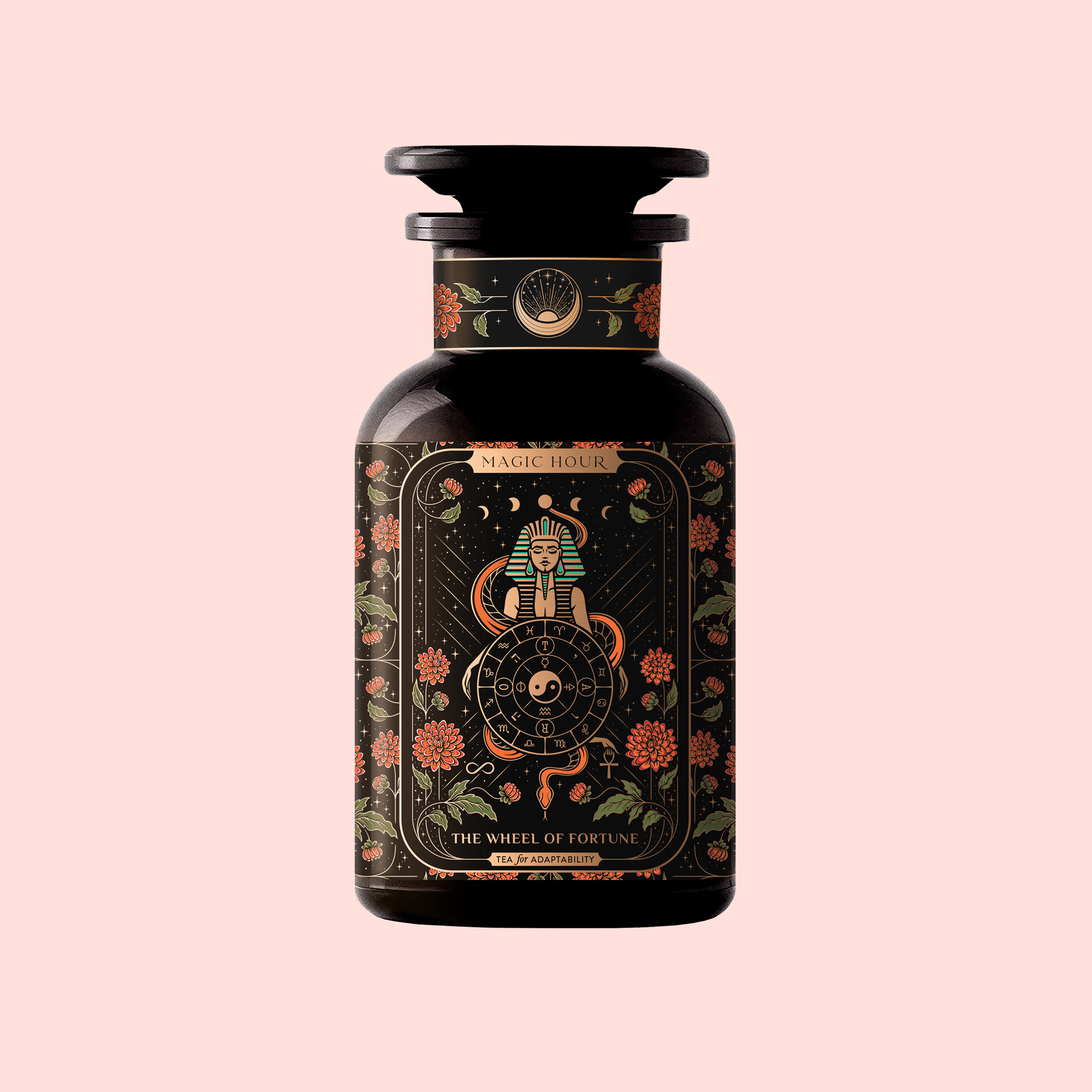 A dark glass bottle labeled "The Wheel of Fortune: Ginseng Spice Tea for Adapting to Change" features ornate floral designs, a mystical sphinx and wheel, and celestial accents on a pale pink background—suggesting a caffeine-free wellness tea.