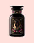 A dark glass bottle, adorned with floral designs and gold lovers artwork among pink blooms, contains The Lovers Hibiscus-Cinnamon-Vanilla Love Potion infused with Damiana. The label reads "VI The Lovers." Set on a pale pink background.