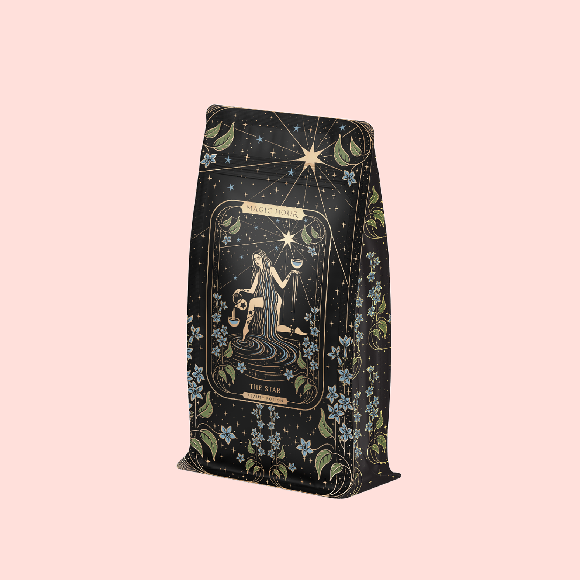 A decorative tea bag with a celestial woman, stars, and florals on pastel pink. The label reads "Magic Hour" and "The Star," featuring The Star: Vanilla-Ginger Beauty Potion with Jasmine &amp; Shatavari, an organic herbal blend.