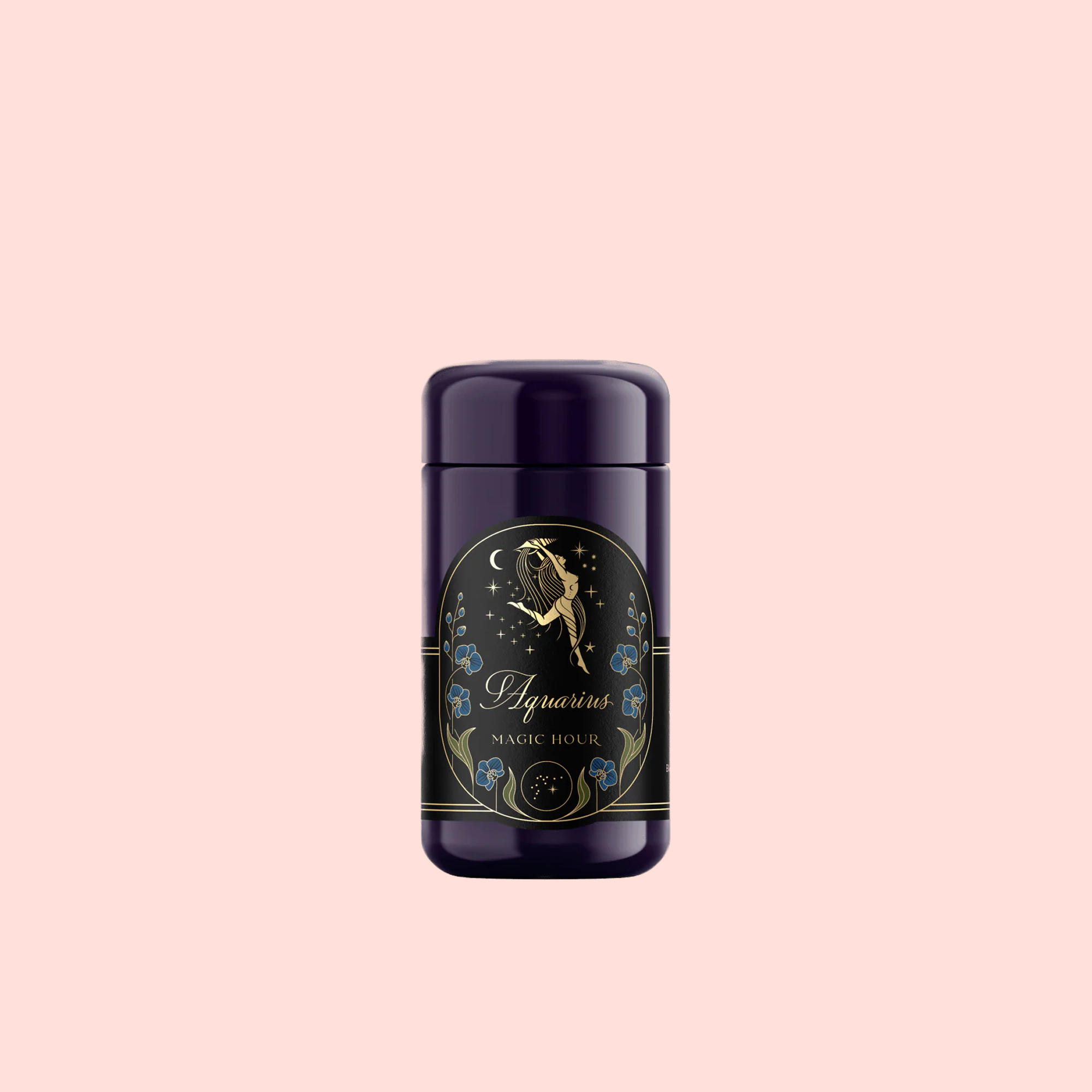 A dark purple cylinder labeled with an angel or fairy, blue flowers, and “Aquarius: Visionary Goddess Tea”—perfect for displaying vanilla black tea on a pale pink background.