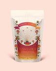 A white tea pouch labeled "Tea for Energy: Bohemian Breakfast: Rich Puerh Black Tea Blend" features floral designs, rays, and a sun. The text highlights its support for energy and digestion with a probiotic-rich black tea blend inspired by the Solar Plexus Chakra—a ceremonial tea made with love.