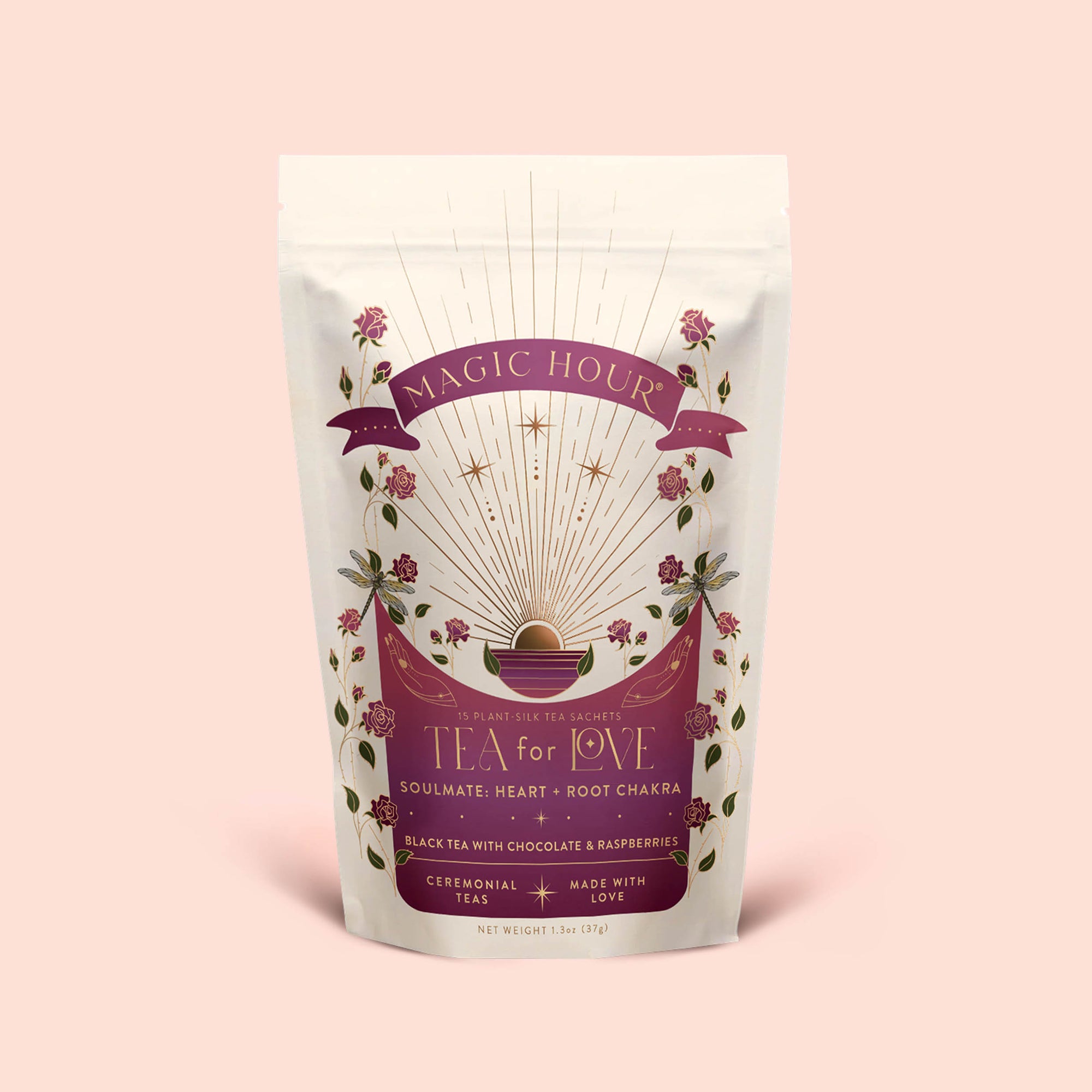 A bag of Tea for Love: Soulmate: Black Tea with Chocolate &amp; Raspberries, beautifully adorned with floral designs and shimmering gold rays, labeled for soulmate, heart, and root chakras. This magical blend features fair-trade black tea infused with chocolate and raspberries—a perfect rose petal tea to invite romance into every sip.