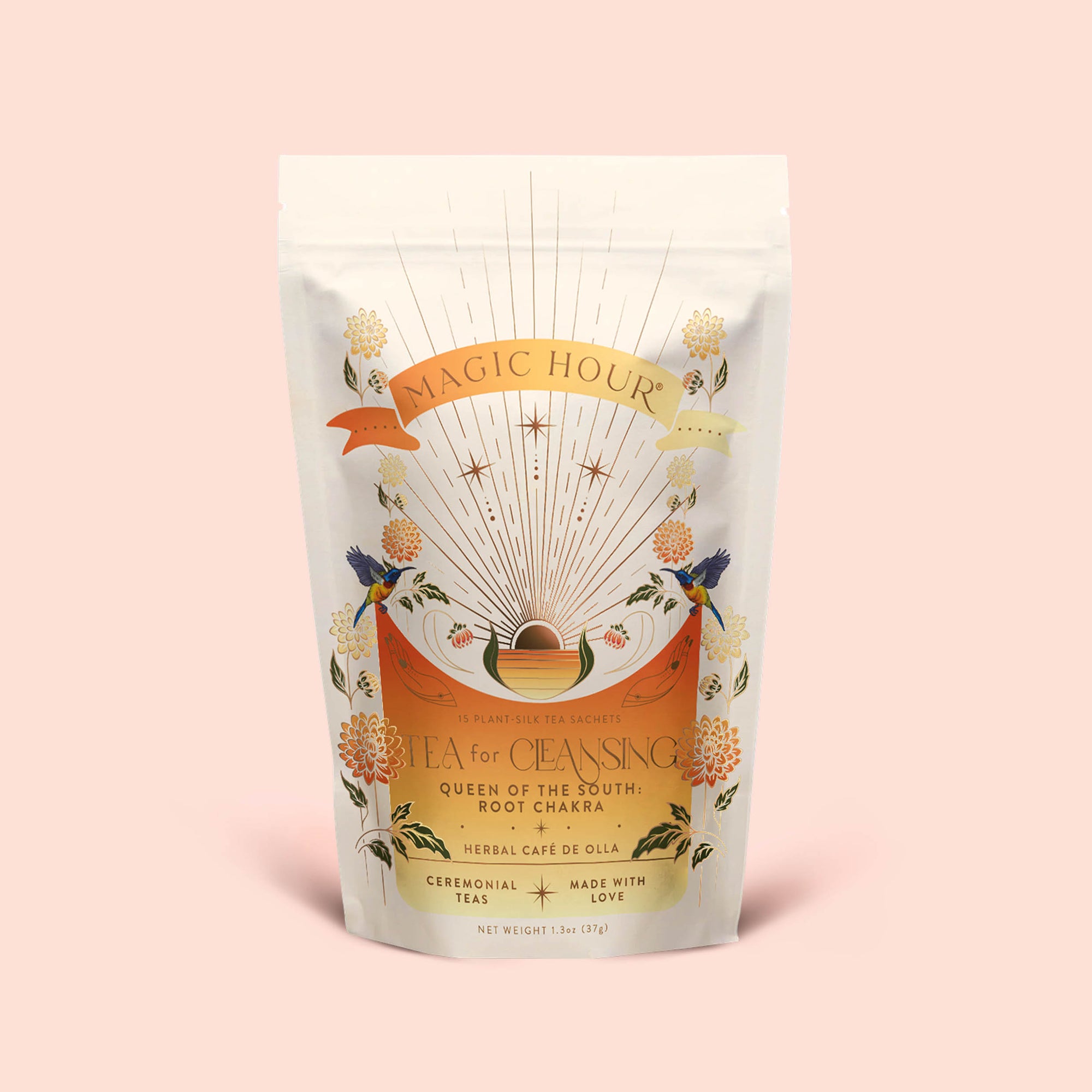 A white pouch of Magic Hour Tea for Cleansing: Queen of the South: Herbal Cafe de Olla features floral designs and sunburst art on a light pink background; this antioxidant-rich, naturally caffeine-free Cocoa Detox Tea is labeled as Root Chakra herbal café de olla.