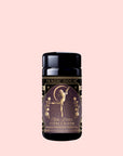 A black tea canister labeled “Flora In Bloom: Peach Moonlight White Tea” features an illustration of a woman and flowers on a pink background, inspired by the elegance of Moonlight White Tea.