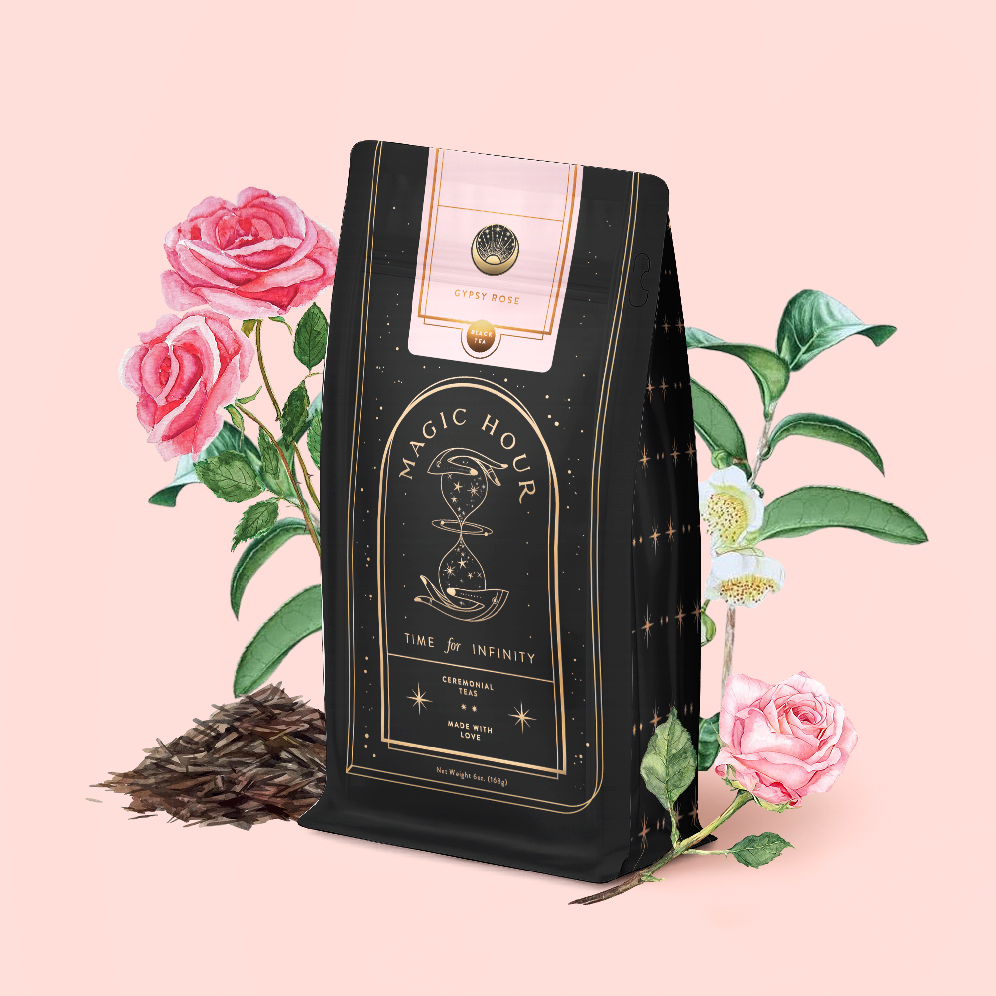 A black bag of Gypsy Rose Black Tea stands before illustrated pink roses and green leaves on a pale pink background, with loose organic black tea leaves scattered at its base.