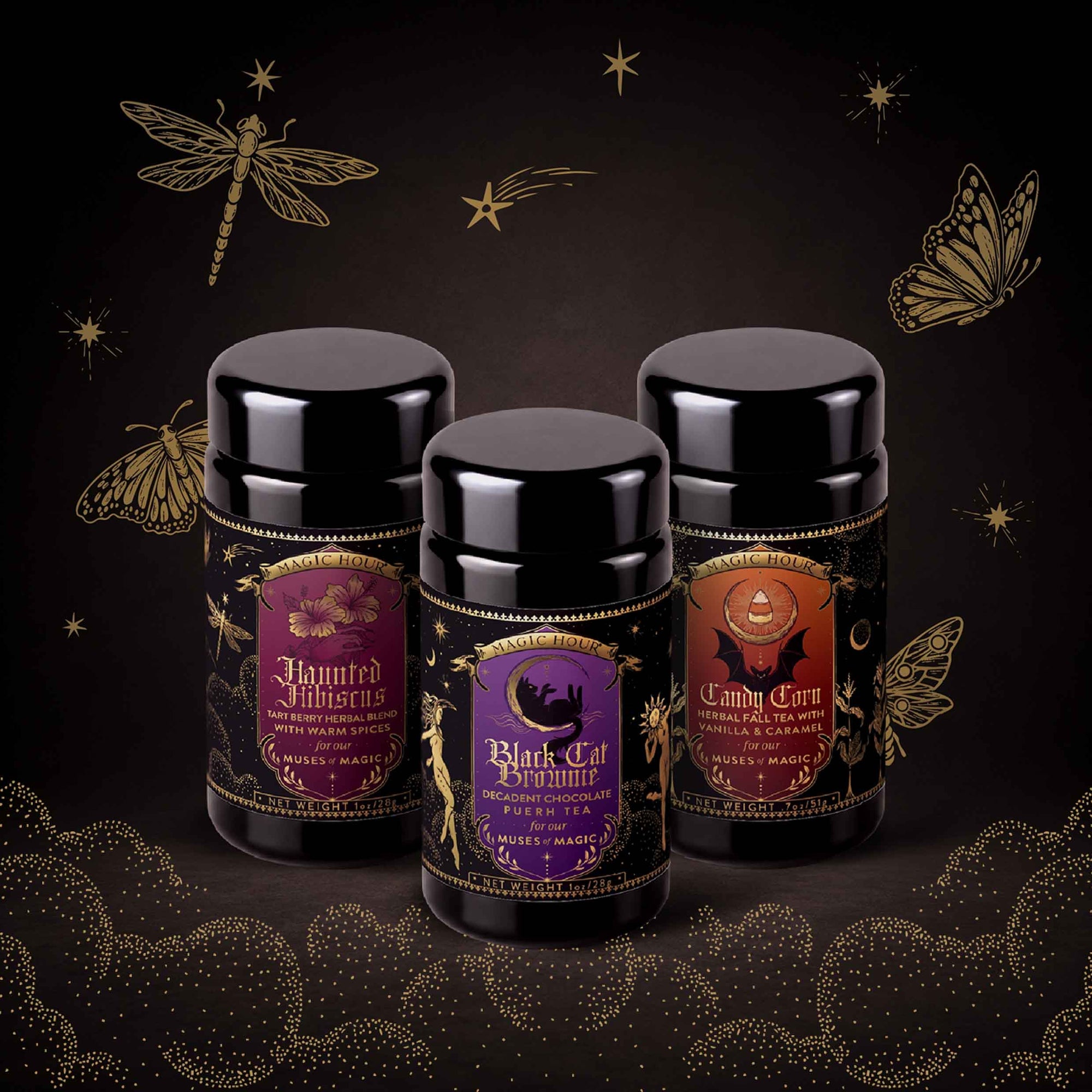 Three black tea tins with Halloween-themed labels—Haunted Hibiscus, Black Cat Boheme, and Candy Corn—stand against a dark background adorned with gold illustrations of a dragonfly, butterfly, and swirling stars. The Halloween Bundle features limited-release teas in hand-crafted blends, perfect for elevating your spooky season sipping.