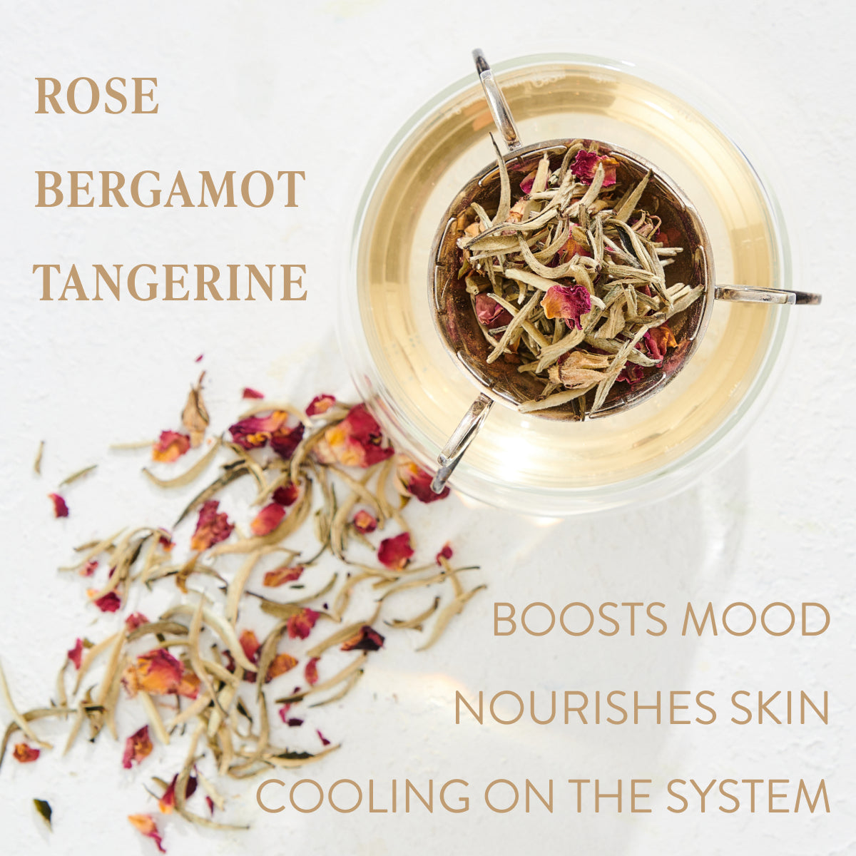 A glass teapot filled with hot water and dried tea leaves, including rose petals, is displayed alongside loose leaf tea on a light surface. Text on the image reads: "Rose, Bergamot, Tangerine. Boosts Mood, Nourishes Skin, Cooling on the System." Indulge in this organic Magic Hour Harmonize White Tea experience.