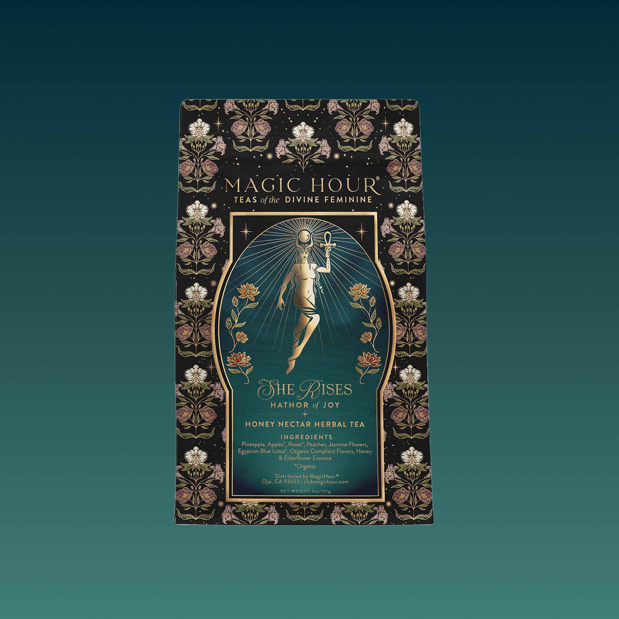 A decorative box for the Monthly Magic Tea Journey Subscription celebrates herbal wellness, featuring an ornate floral border and a woman with an ankh amid celestial motifs on a gradient teal background.