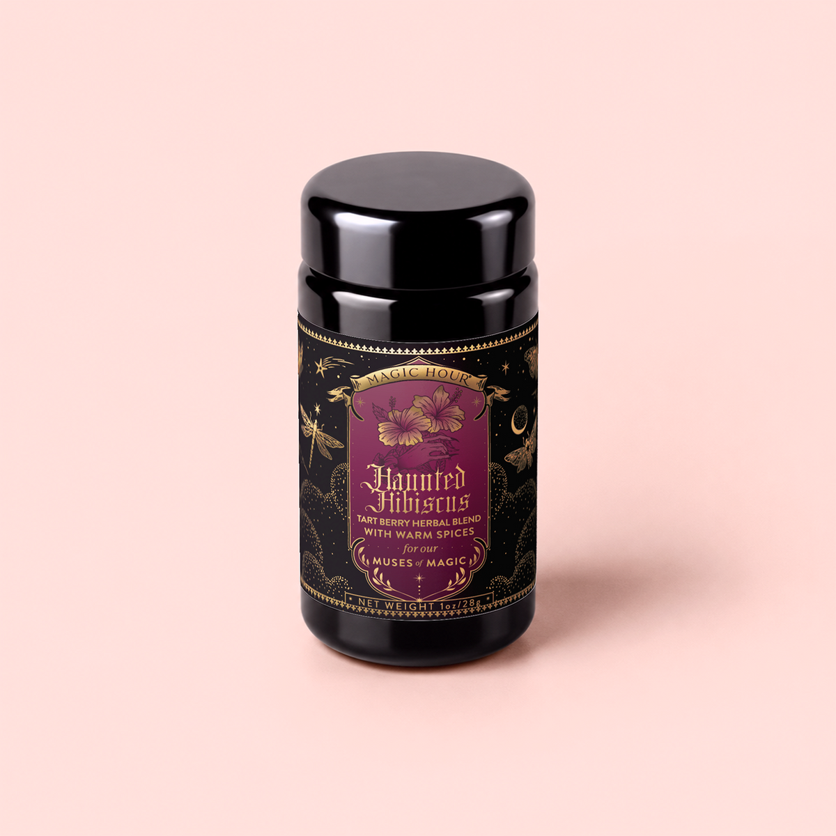A tea canister labeled “Haunted Hibiscus: Tart Berry Herbal Blend with Warm Spices” features gold and purple decoration with botanical and mystical elements. It sits on a light pink background, and the label describes this caffeine-free blend as inspired by haunted hibiscus notes and vibrant hibiscus tea undertones.