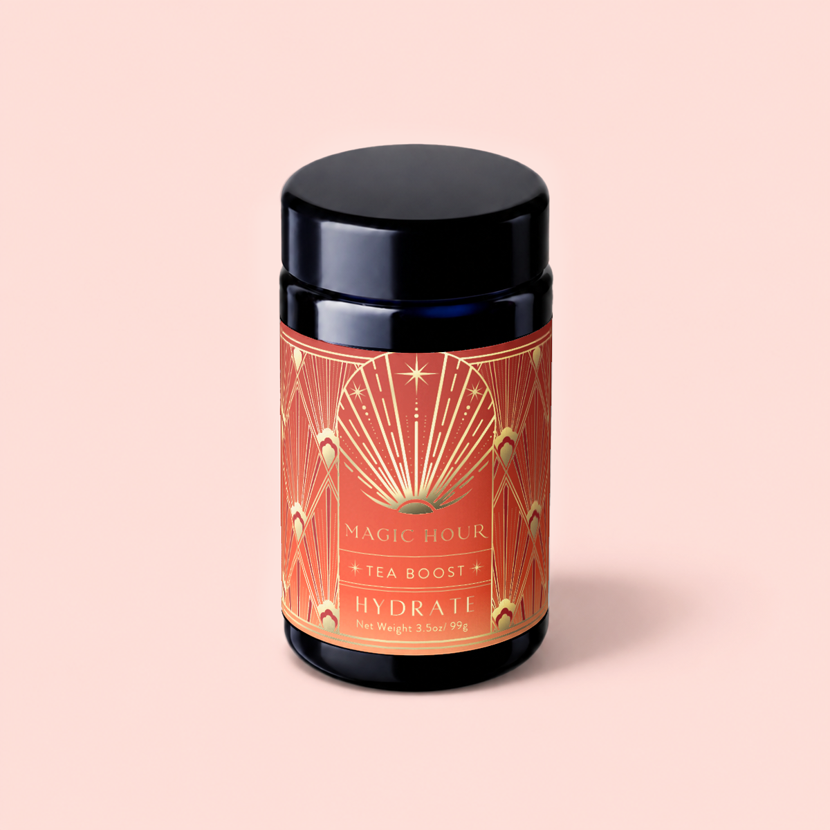 A black canister labeled “Hydrate Tea Boost” in ornate orange and gold rests on a light pink background, inviting you to enjoy this nutrient-rich botanical elixir designed to enhance your daily tea ritual.