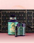 The Jupiter Bath & Beauty Box features three luxury wellness products—one large bottle, one small bottle, and one jar—displayed in front of a black, starry box with gold accents and a “Magic Hour” ribbon for a celestial self-care experience.