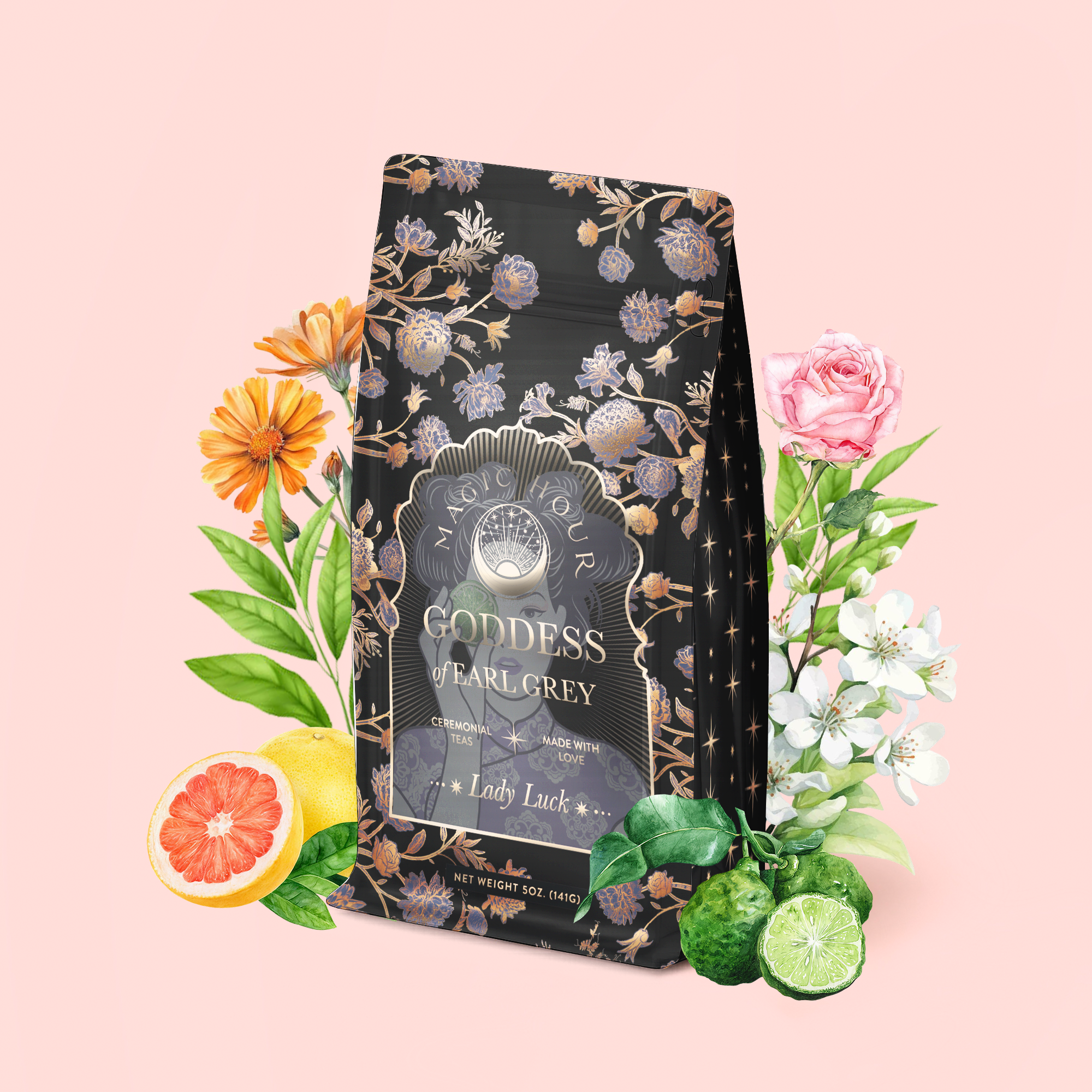 A beautifully floral-decorated tea bag labeled "Goddess of Earl: Lady Luck Oriental Beauty Oolong Tea" rests amid vibrant flowers, fresh grapefruit, and bergamot on a pale pink background, evoking the delicate aroma of an Oriental Beauty Oolong blend.