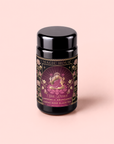 A black tea canister labeled “Lakshmi in Abundance: Rose Saffron Black Tea for Good Fortune & Radiance,” adorned with ornate floral designs and an illustration of a woman in a pink sari, perfectly capturing the essence of this antioxidant-rich tea.