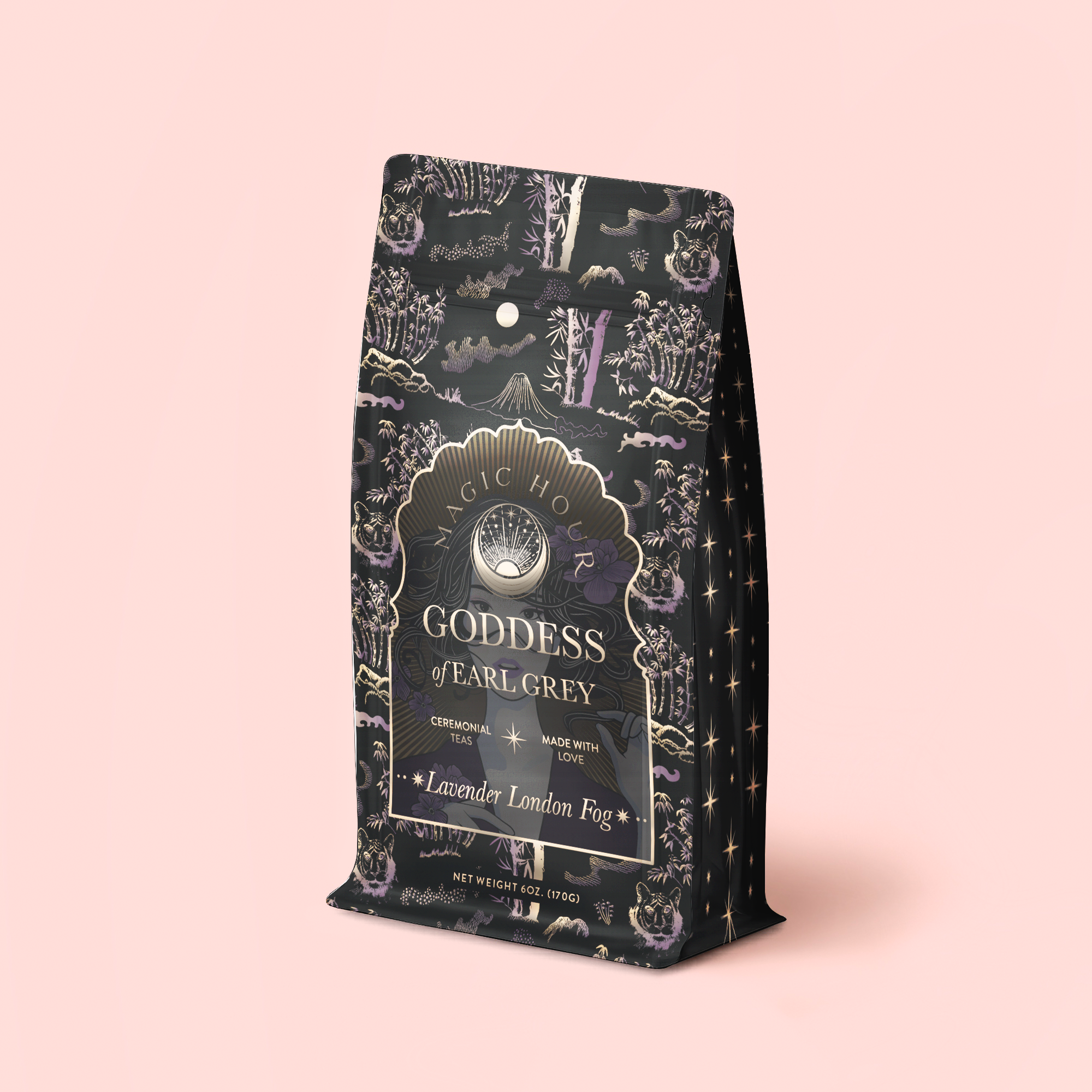 A decorative black tea refill pouch labeled "Lavender London Fog Earl Grey" sits on a light pink background. The packaging features ornate gold and lavender designs with stars and celestial elements, capturing the enchanting essence of Earl Grey tea blended with soothing lavender and bright bergamot notes.