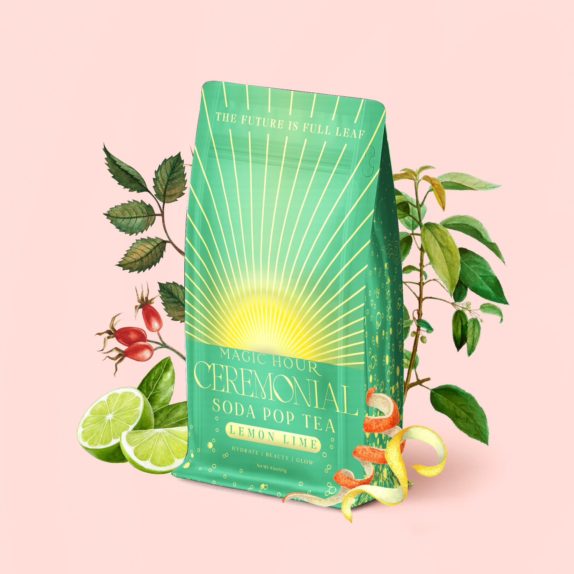 A green bag of Lemon Lime Green Tea: Ceremonial Soda Pop Tea is displayed on a light pink background, surrounded by fresh lemon and lime slices, rose hips, and tea leaves. Accented with golden rays and elegant typography, this vibrant blend harmoniously combines the zesty brightness of lemon tea with premium green tea leaves and a unique touch of gymnema sylvestre.