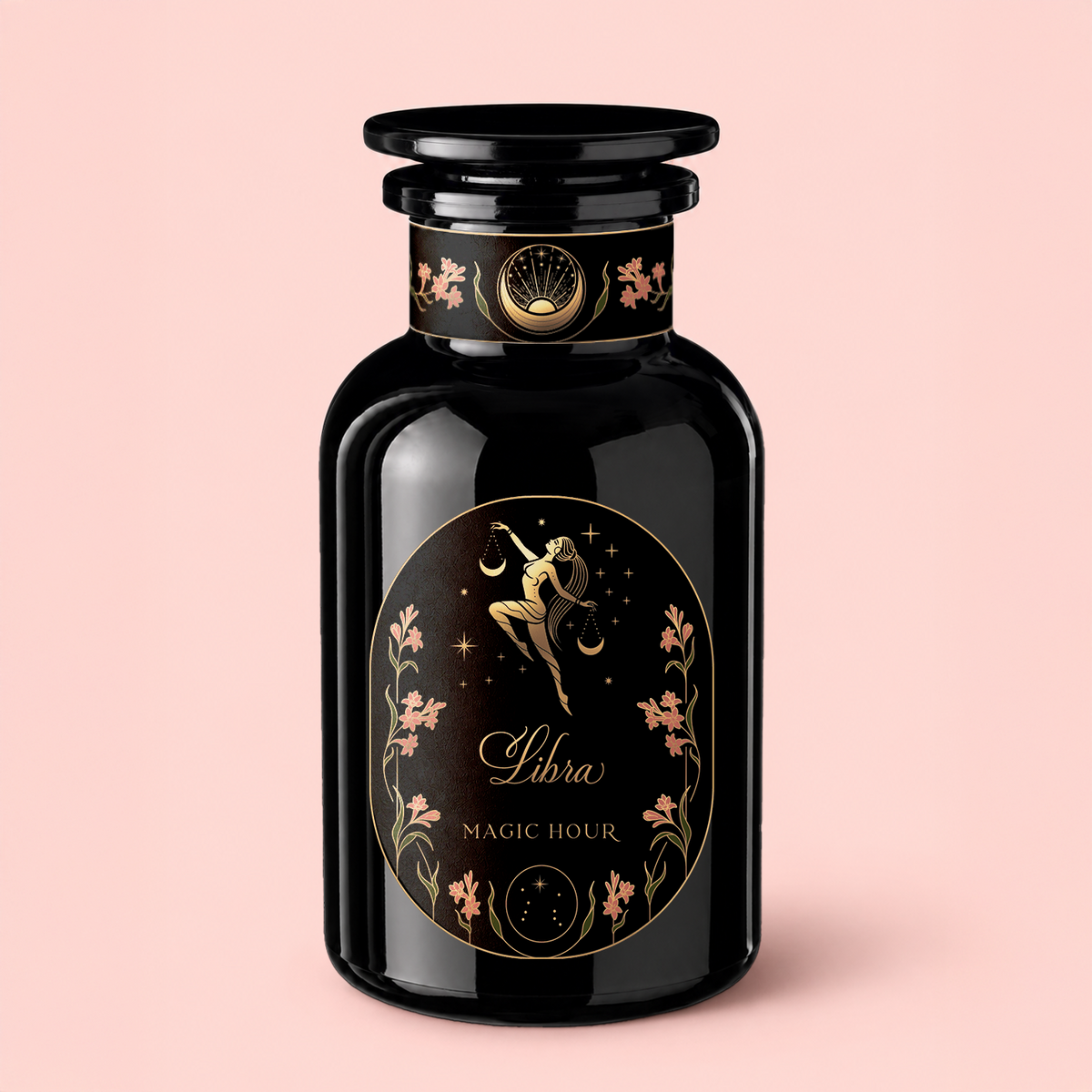 A black glass bottle with a gold and pink label adorned with zodiac Libra imagery, delicate floral details, and the words “Libra Shatavari-Cardamom-Rose White Love Cake Tea,” displayed on a pale pink background—an enchanting vessel inspired by Persian love cake tea, evoking subtle notes of rose pistachio tea.