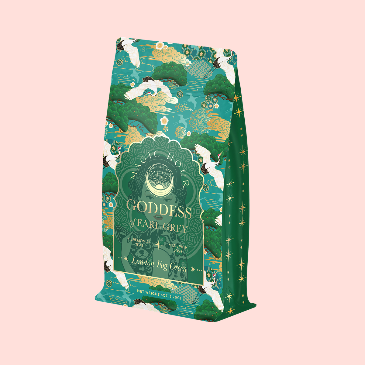 The elegant "London Fog Green" tea package showcases a decorative green and gold design with crane, cloud, and tree illustrations on a light pink background. The tea offers a fragrant allure with delicate notes of lavender intertwined with bergamot.