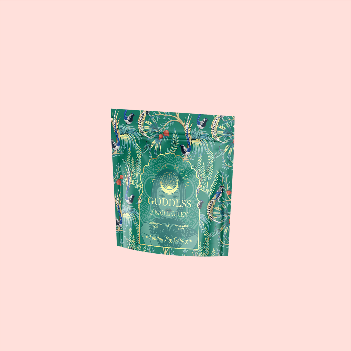 A decorative teal packaging of &quot;London Fog Oolong&quot; tea with ornate floral and leaf patterns, featuring a gold-lettered label against a light pink backdrop, hinting at the rich bergamot aroma within.