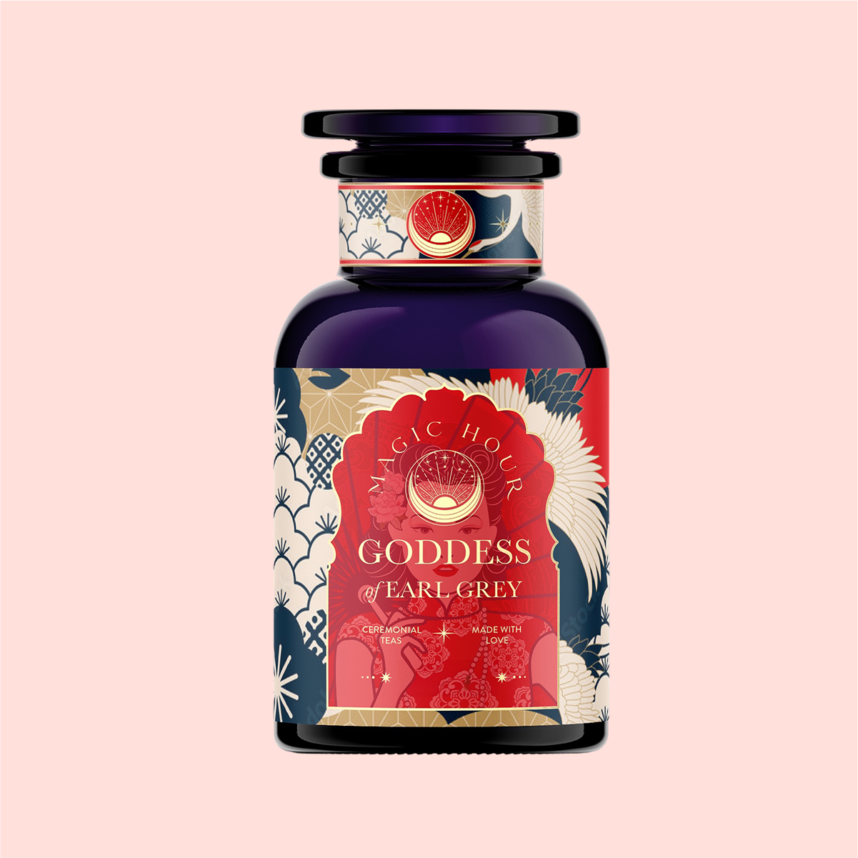 The &quot;London Fog Rooibos&quot; dark bottle, adorned with floral and celestial patterns in blue, red, and cream, features a sun emblem against a pink background. This caffeine-free blend is infused with bergamot for a citrusy twist and crafted with love for an enchanting allure.