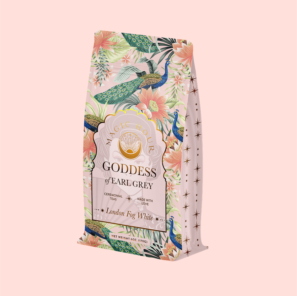 A decorative tea package featuring floral and peacock patterns, labeled "Magic Hour Goddess of Earl Grey," contains ceremonial tea with bergamot. The product is named London Fog White, set against a pale pink background.