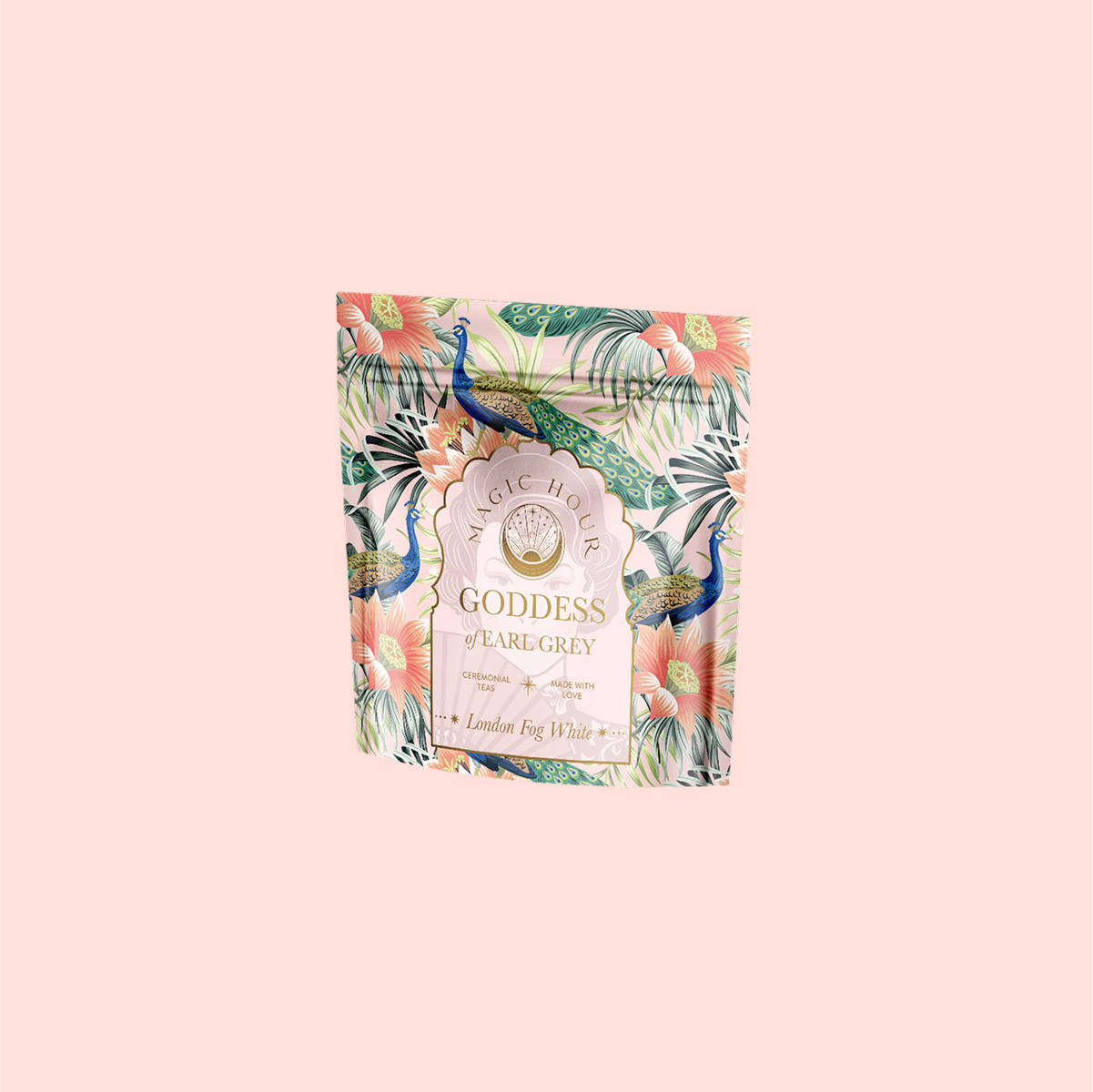 A pastel pink package of &quot;London Fog White&quot; tea features vibrant peacocks and tropical flowers in teal and coral, with a hint of bergamot. The design is elegant and lively, creating an exotic and luxurious feel.