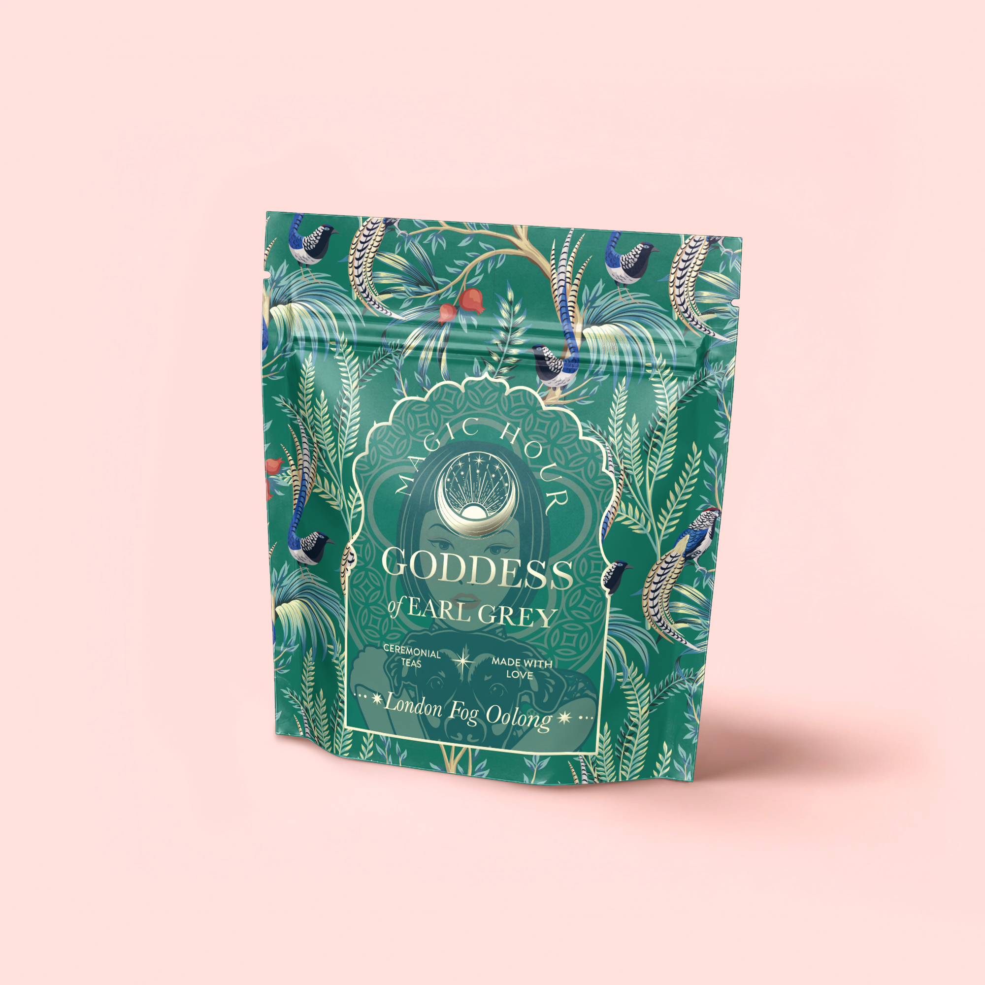 A green, floral-patterned stand-up pouch labeled "London Fog Oolong" with peacock and leaf designs sits against a light pink background. The packaging highlights notes of bergamot and vanilla, Magic Hour, and Quan Yin oolong.