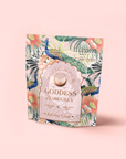 A standing pouch of "London Fog White" tea features a colorful peacock, tropical leaves, and flowers on pale pink. The label highlights "Ceremonial Tea," "Made With Love," and fragrant bergamot with Bai Mudan white tea.