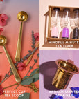 A vibrant display of tea accessories from the Loose Leaf Tea Starter Set features the "Perfect Cup Tea Scoop," a pair of gold measuring spoons on a floral backdrop, "Mindful Minutes Tea Timer," boxed sand timers, and the "Artisan Star Tea Strainer" in gold.