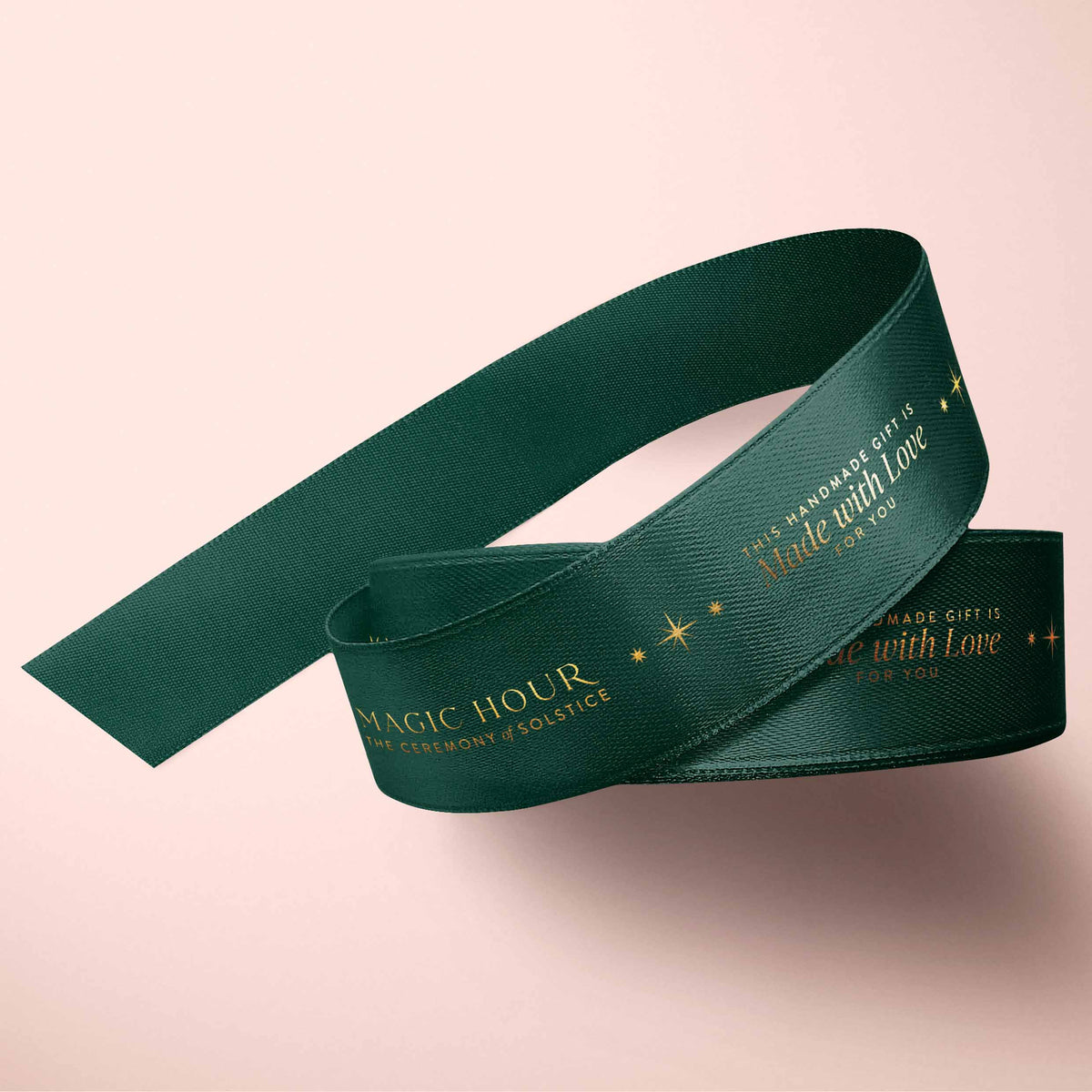 Magic Hour Ribbon: Green &amp; Gold coiled in a loop, featuring gold foil text that reads “Magic Hour: The Ceremony of Solstice” and “This handmade gift is made with love.”