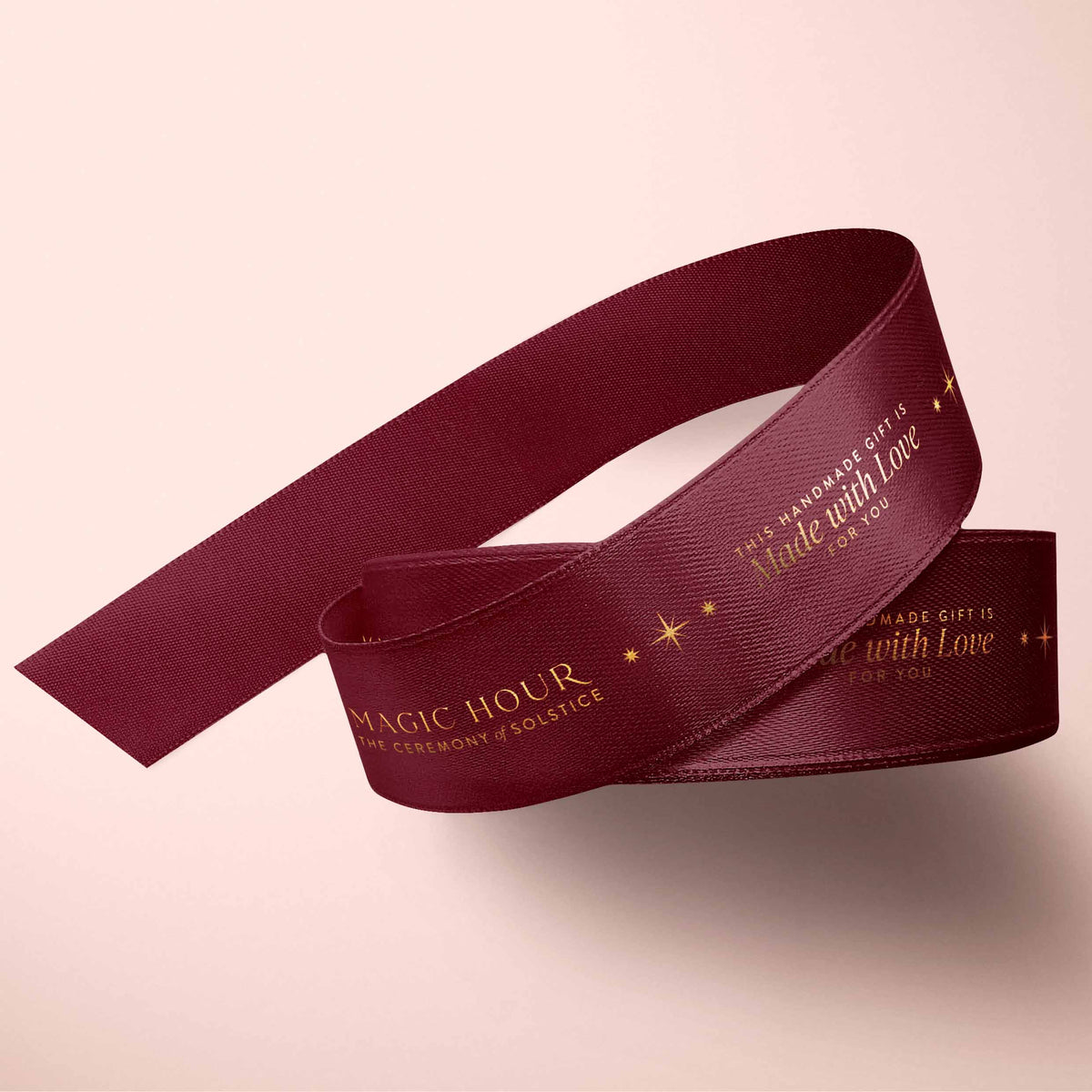 Magic Hour Ribbon: Red &amp; Gold featuring dark red ribbon printed with gold stars and the text “MAGIC HOUR THE CEREMONY OF SOLSTICE” and “THIS HANDMADE GIFT IS Made with Love FOR YOU.”