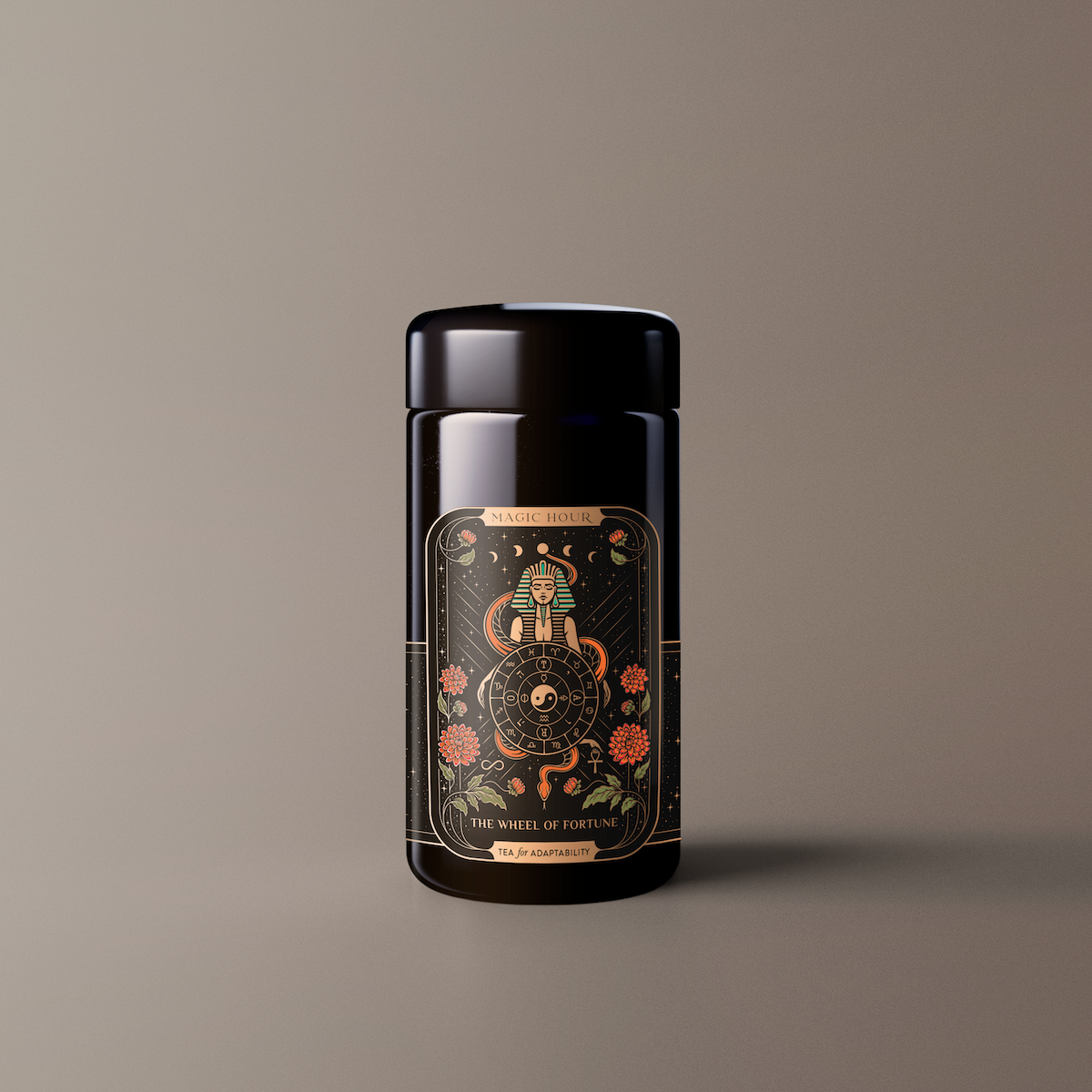 Product Description: The Wheel of Fortune is a dark cylindrical container adorned with a detailed, ornate label. This label showcases an illustration inspired by the &quot;Wheel of Fortune&quot; tarot card and features intricate designs, vibrant flowers, and mystical symbols in gold, red, and green hues on a black background.